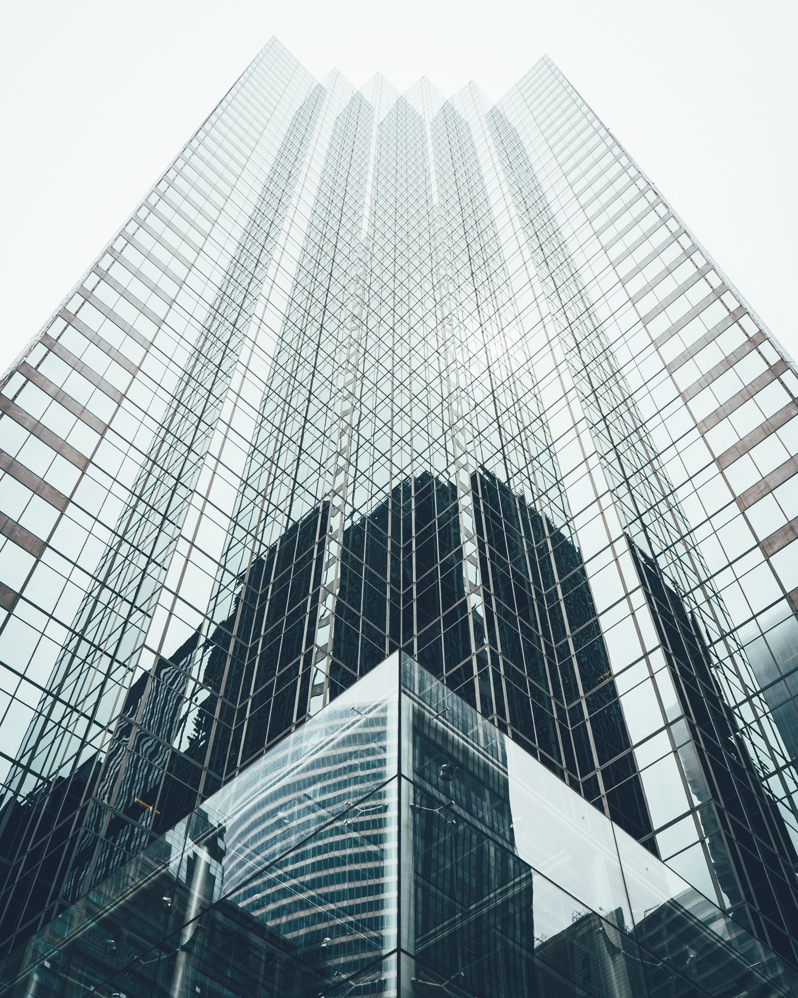 A modern glass office tower photographed from street level