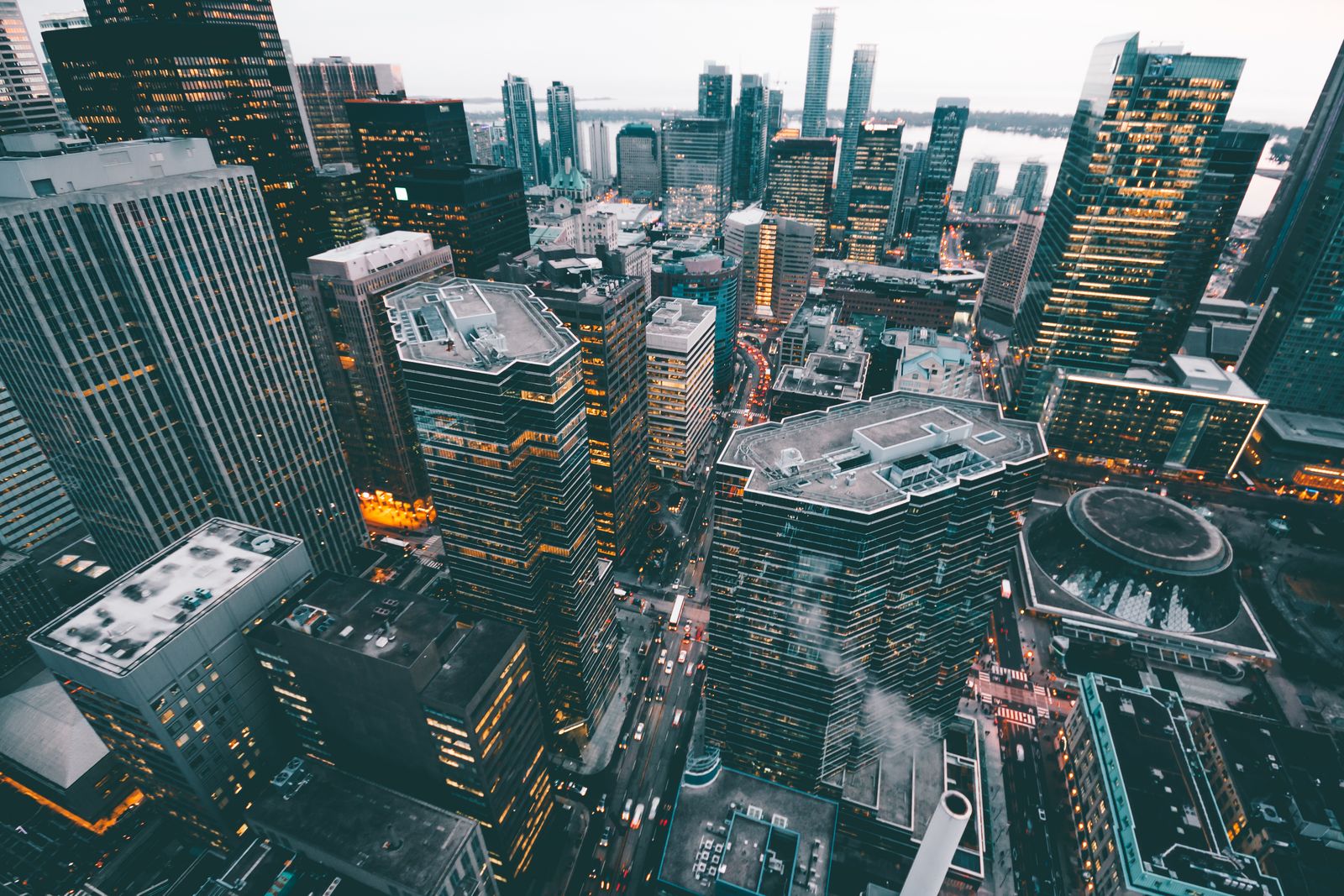 An aerial view of commercial buildings in a financial district at dusk
